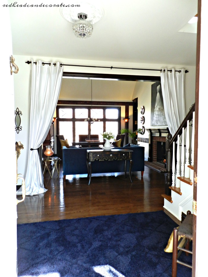 Never thought of this before! Grommet curtain panels hung in the entry way make a dramatic statement.