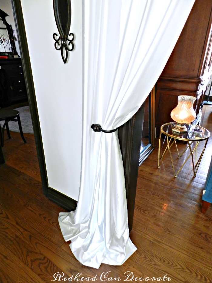 Never thought of this before! Grommet curtain panels hung in the entry way make a dramatic statement.