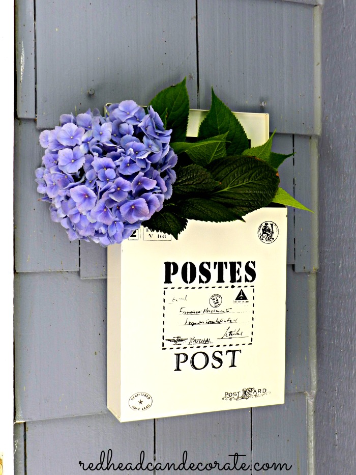 What a cute vintage style mailbox to hang by your door even if you don't need one there. She fills hers with flowers!