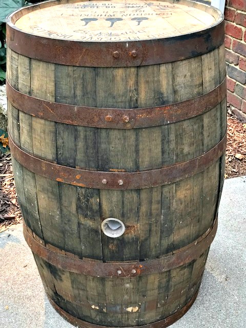 What a fantastic idea to turn a whiskey barrel hoop into a Fall wreath using some wood and other Fall decorations.