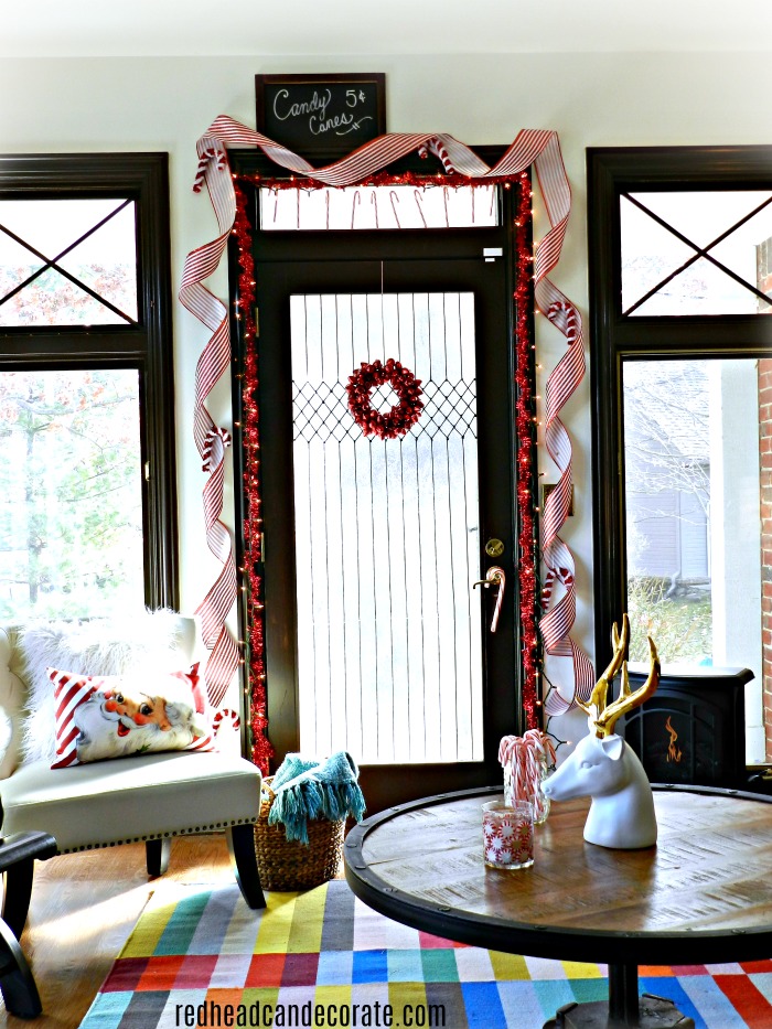 What a gorgeous idea to decorate a "candy cane door" for Christmas. She also used gallery glass to make her window look frosted!