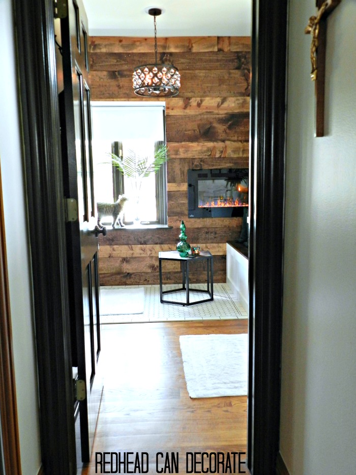 This Michigan DIY blogger and husband removed their dated jacuzzi tub and then transformed their entire master bathroom into a cozy rustic retreat complete with an electric fireplace. A must see! Master Bathroom Renovation-The Full Reveal