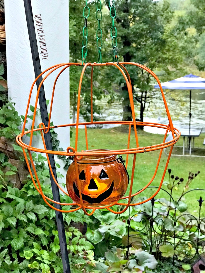This Dollar Store Hanging Jack-O'-Lantern would look so cute on a porch or lined up on a sidewalk!