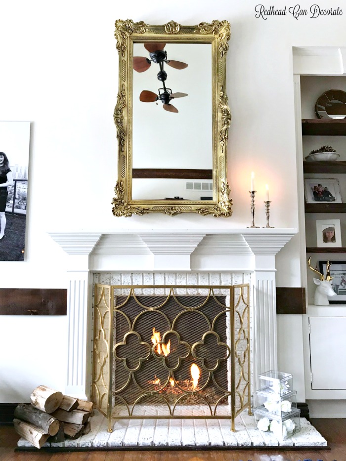 This gorgeous thrift store mirror is a perfect fit for this traditional mantel.  Learn how to hang heavy wall decor with ease!