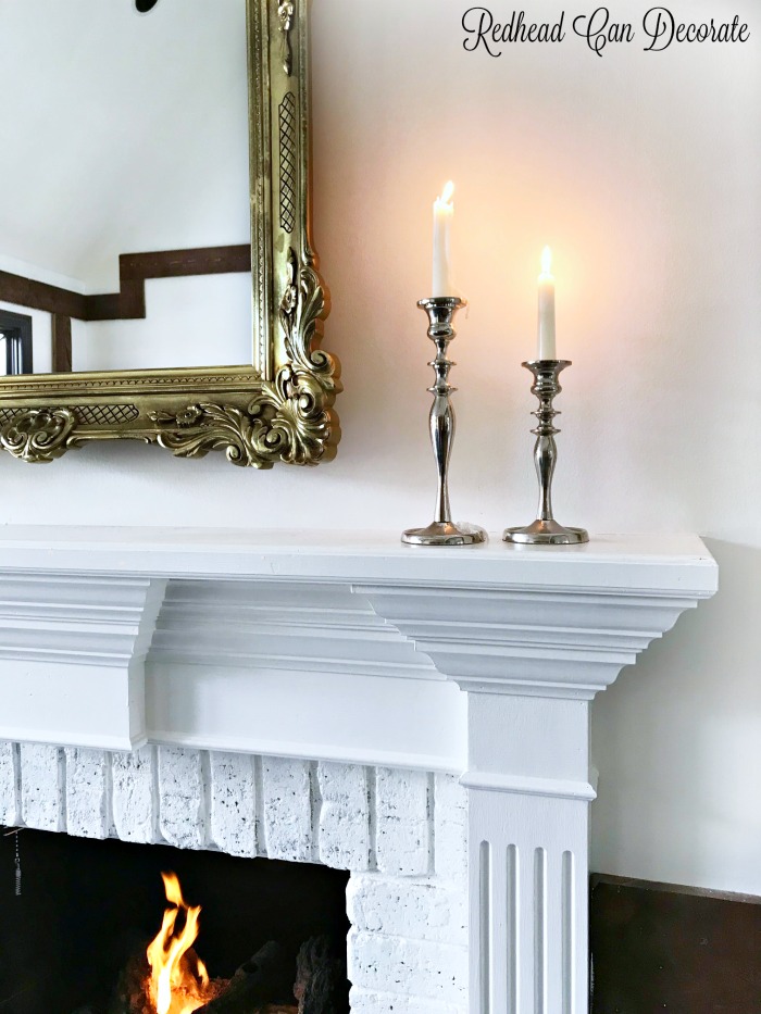 This gorgeous thrift store mirror is a perfect fit for this traditional mantel.  Learn how to hang heavy wall decor with ease!