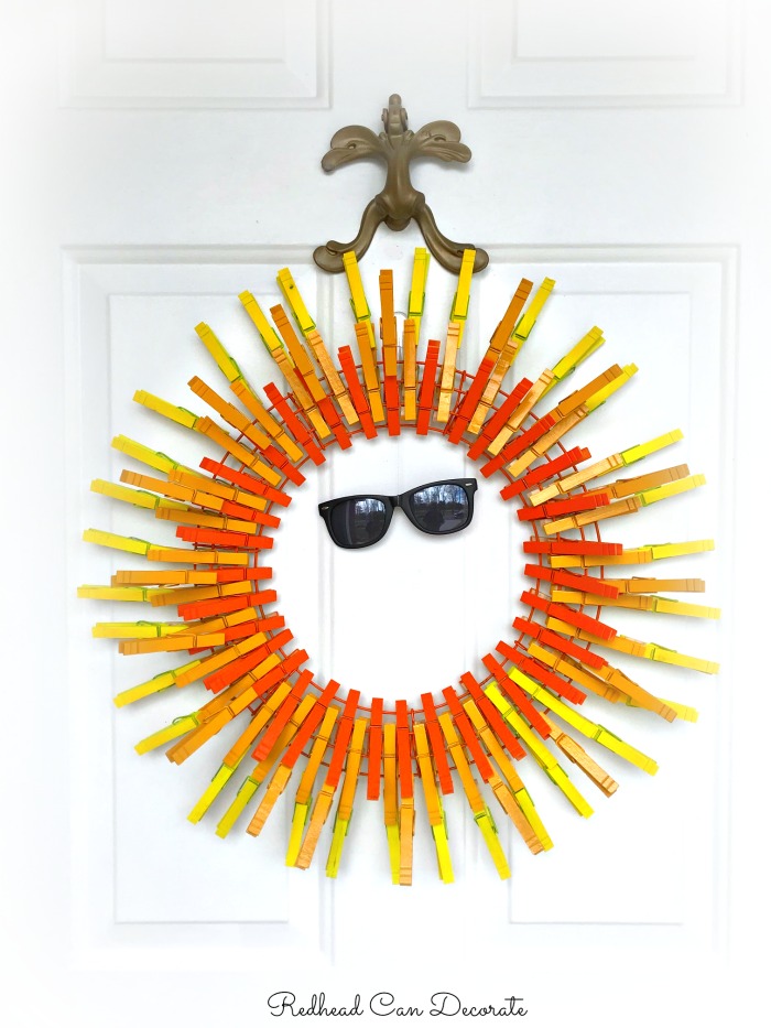 ThIs do it yourself crafty bright and cheery sun clothespin wreath can be made in minutes with household clothespins and spray paint!
