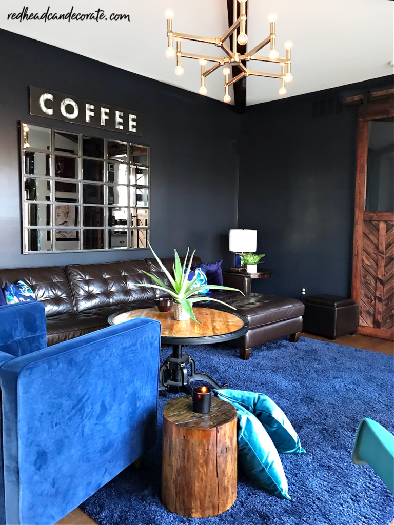 This gorgeous blue grey color looks amazing as a back drop in this beautiful family room (Zen Lounge Blue) a mom created during the pandemic to help her family relax.  The wood barn door is a must see!